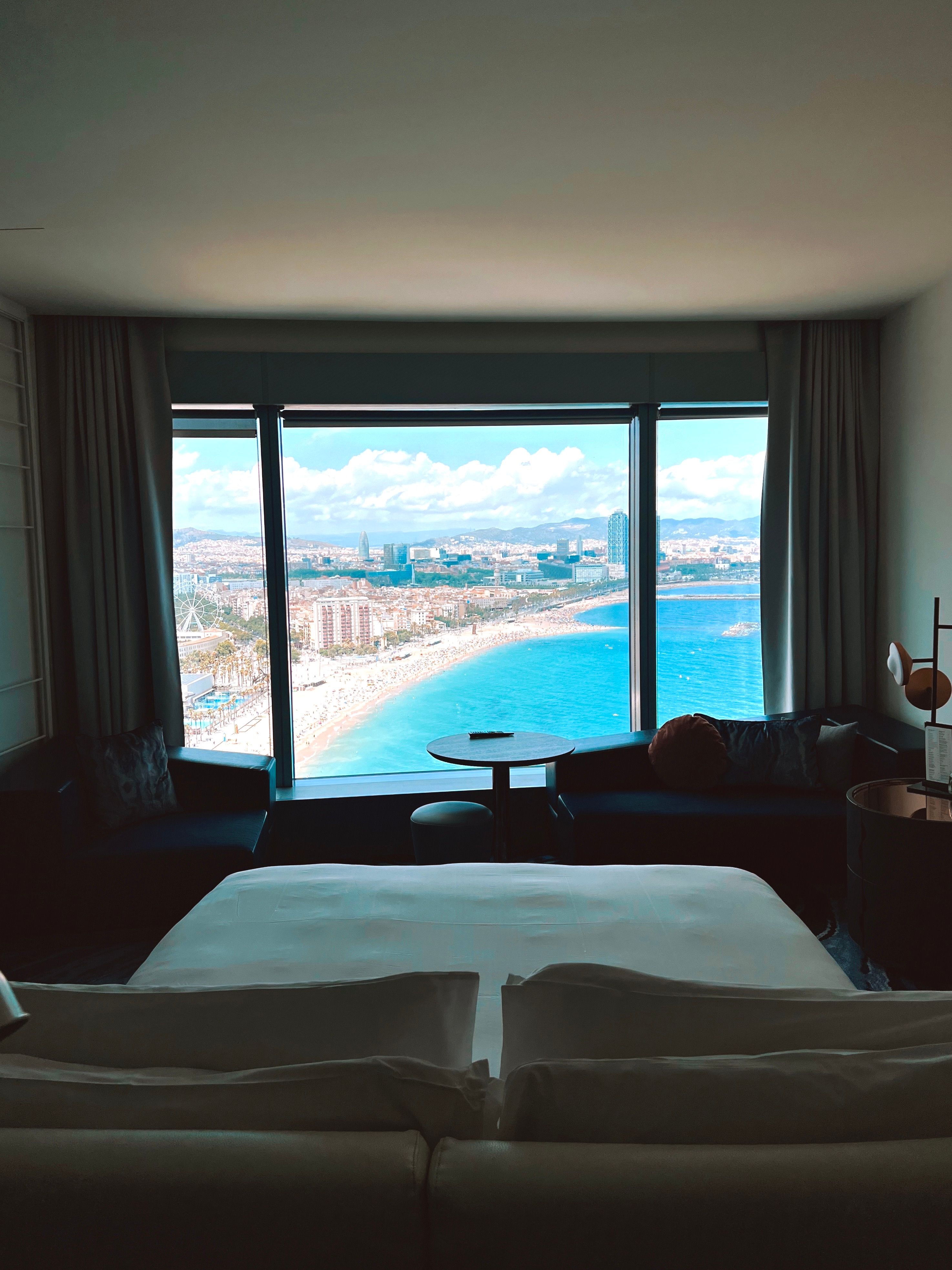 Luxurious hotel suite with a stunning beach and city view from a large window