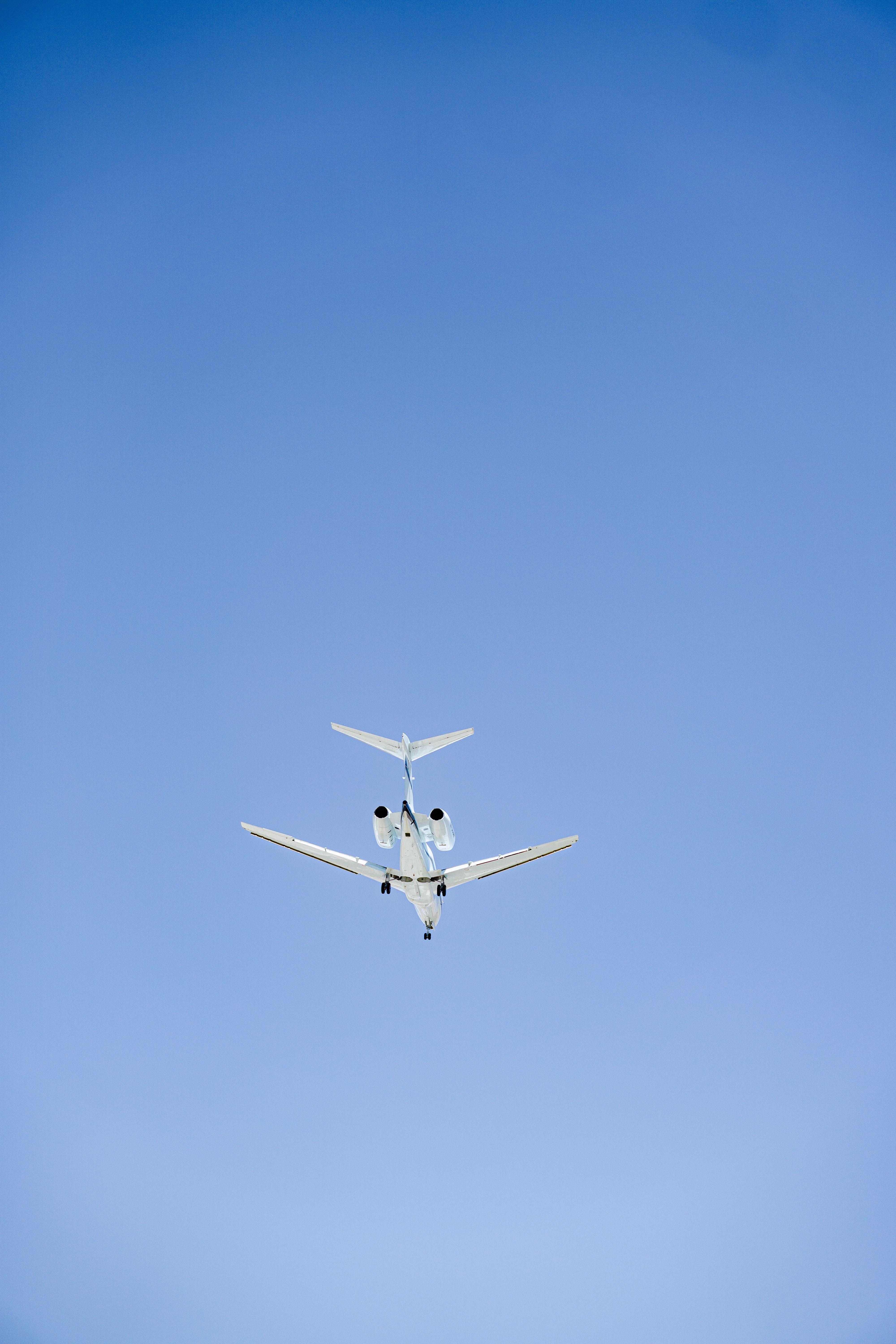 A sleek private jet ascends into a clear blue sky, showcasing modern air travel